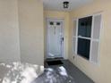 Bright entryway with storm door and paneled window on a stucco exterior at 9117 Sw 93Rd Cir, Ocala, FL 34481