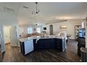 Modern kitchen featuring a large island and dark blue cabinets at 12495 Se 102Nd Ave, Belleview, FL 34420