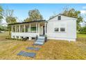 Newly renovated home with a large front porch and mature trees at 217 Nw 14Th St, Ocala, FL 34475