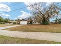 House exterior view showcasing a large yard and a wide driveway at 3720 Se 24Th St, Ocala, FL 34471