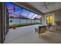Covered screened patio featuring neutral concrete floors and framed view of the backyard at 6407 Sw 45Th Ave, Ocala, FL 34474