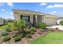 Landscaped front yard featuring lush plants and decorative accents enhancing curb appeal at 7682 Sw 89Th Ct, Ocala, FL 34481