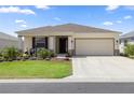 Charming single-story home featuring a well-manicured lawn and an attached two-car garage at 7682 Sw 89Th Ct, Ocala, FL 34481