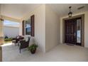 Inviting front porch with comfortable seating and charming decor, creating a welcoming entrance at 7682 Sw 89Th Ct, Ocala, FL 34481