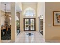 Open and airy entryway with double doors and view to living room at 2215 Se Spring Hill Ct, Ocala, FL 34471