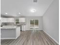 Dining area adjacent to kitchen with hardwood flooring and view of backyard at 24268 Sw Tiger Lake W Blvd, Dunnellon, FL 34431