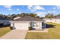 Inviting one-story home featuring a two-car garage and well-maintained lawn on a sunny day at 4955 Se 89Th Place Rd, Ocala, FL 34480