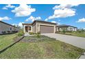 Front view of a single-story house with a two-car garage at 5624 Sw 88Th Ave, Ocala, FL 34481