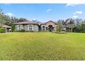 One-story house with manicured lawn and American flag at 7451 Se 24Th Ter, Ocala, FL 34480