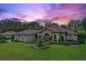 House exterior at sunset, landscaping and American flag visible at 7451 Se 24Th Ter, Ocala, FL 34480