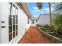 Brick paved back patio with access door and lush landscaping at 9260 Sw 92Nd Place Rd, Ocala, FL 34481