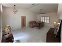 Open living room with neutral tones, tile flooring, ceiling fan, and cozy seating at 9625 Sw 207Th Cir, Dunnellon, FL 34431