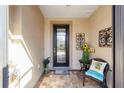Inviting front porch with stylish decor, a decorative front door, and neutral wall colors at 10129 Sw 77Th Loop, Ocala, FL 34481