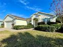 One-story house featuring a two-car garage and lush landscaping at 1033 Sw 159Th St, Ocala, FL 34473
