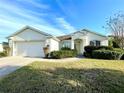 One story house with a two-car garage and well-maintained lawn at 1033 Sw 159Th St, Ocala, FL 34473