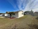 Side view of a single story house with landscaping and a palm tree at 10949 Sw 79Th Ter, Ocala, FL 34476