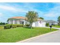 House with a two-car garage and manicured lawn, featuring bay windows at 11702 Se 173Rd Lane Rd, Summerfield, FL 34491