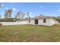 Expansive backyard featuring lush grass, a privacy fence, and views of surrounding trees, perfect for outdoor activities at 13143 Sw 67Th Ave, Ocala, FL 34473