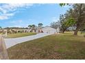 House exterior with a three car garage and a large yard at 17999 Se 99Th Ave, Summerfield, FL 34491