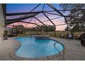 Relaxing screened pool and spa area with sunset views at 17999 Se 99Th Ave, Summerfield, FL 34491