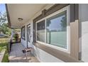 Covered front porch with tiled flooring and a small side table at 20131 Sw 82Nd Pl, Dunnellon, FL 34431