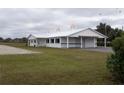 White horse barn with cupola and covered breezeway at 2190 Nw 110Th Ave, Ocala, FL 34482