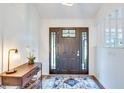 Bright and airy foyer with a dark wood door and stylish decor at 2263 Se Laurel Run Dr, Ocala, FL 34471
