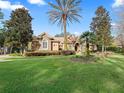 Inviting home with a manicured lawn, stone accents, and mature landscaping at 3000 Nw 79Th Avenue Rd, Ocala, FL 34482
