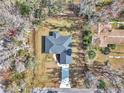 Aerial view of a house and surrounding neighborhood with lush trees at 4065 Sw 5Th Ave, Ocala, FL 34471
