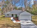 Charming home featuring a two-car garage, manicured landscaping, and a welcoming walkway at 4065 Sw 5Th Ave, Ocala, FL 34471