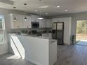 Bright kitchen boasts white cabinetry, modern appliances, and half wall with an eat-in bar at 4698 Sw Zinnia, Dunnellon, FL 34431