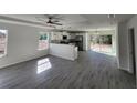 Open floor plan with a modern kitchen and grey vinyl flooring at 4698 Sw Zinnia, Dunnellon, FL 34431