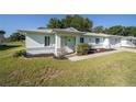 Inviting single-story home featuring a neatly kept lawn and attractive landscaping at 6184 Sw 101St Pl, Ocala, FL 34476