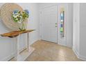 Bright entryway with a wooden console table and a decorative mirror at 772 Horseman Dr, Port Orange, FL 32127