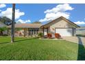 Single-story home with attractive landscaping and a two-car garage at 772 Horseman Dr, Port Orange, FL 32127