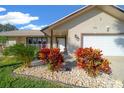 House exterior featuring stone accents and colorful landscaping at 772 Horseman Dr, Port Orange, FL 32127