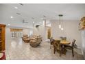 Spacious living room and dining area with tile floors and neutral decor at 8465 Sw 202Nd Ter, Dunnellon, FL 34431