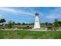 Community entrance with lighthouse feature and fountain at 9802 Se 178Th Ln, Summerfield, FL 34491