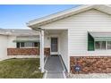 Front entry with walkway, green shutters, and ADT security at 9802 Se 178Th Ln, Summerfield, FL 34491