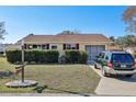 Cute yellow house with carport and well-manicured lawn at 10962 Sw 80 Ct, Ocala, FL 34481