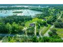 Aerial view showcasing a home's expansive property near a lake at 11540 Se Highway 464, Ocklawaha, FL 32179