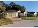 Houses with green roofing, lush landscaping and paved road at 11557 Sw 75Th Cir, Ocala, FL 34476