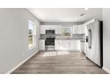 Modern kitchen featuring white shaker cabinets and granite countertops at 13183 Sw 113Th Place, Dunnellon, FL 34432