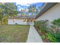 House exterior showcasing walkway and landscaping at 14221 Ne 47Th Ave, Anthony, FL 32617