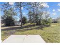 Large backyard with a patio and trees at 15002 Sw 27 St, Ocala, FL 34481