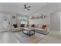 Open concept living room with comfortable seating and wood accent wall at 20 Fir Dr, Ocala, FL 34472