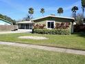 House exterior with green siding and well-manicured lawn at 2241 Brian Ave, South Daytona, FL 32119