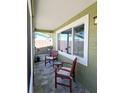 Cozy screened porch with stone tile floor and comfortable seating at 2241 Brian Ave, South Daytona, FL 32119