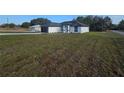 Single-story home with dark roof, black garage door, and a spacious lawn at 262 Locust Rd, Ocala, FL 34472