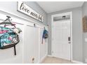 White-paneled entryway with hooks for bags and a decorative sign at 2936 Ne 43Rd Rd, Ocala, FL 34470